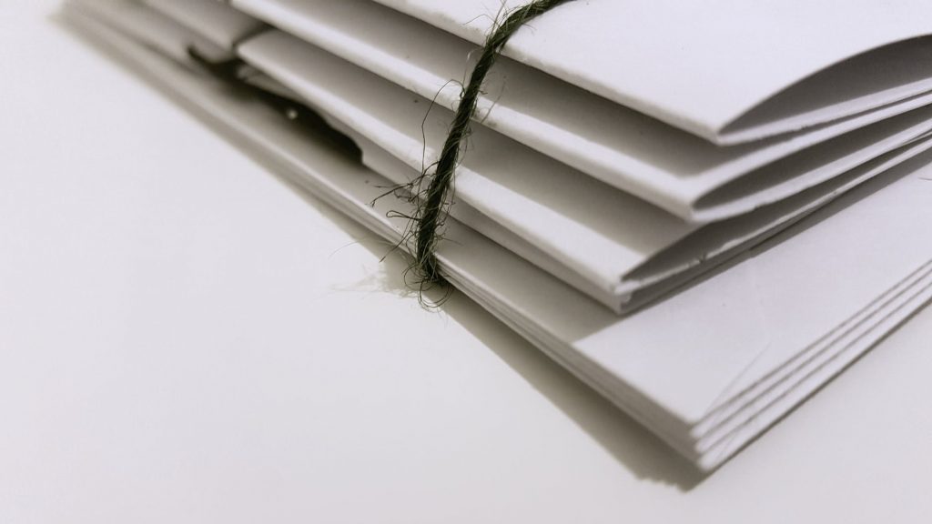 white paper folders with black tie